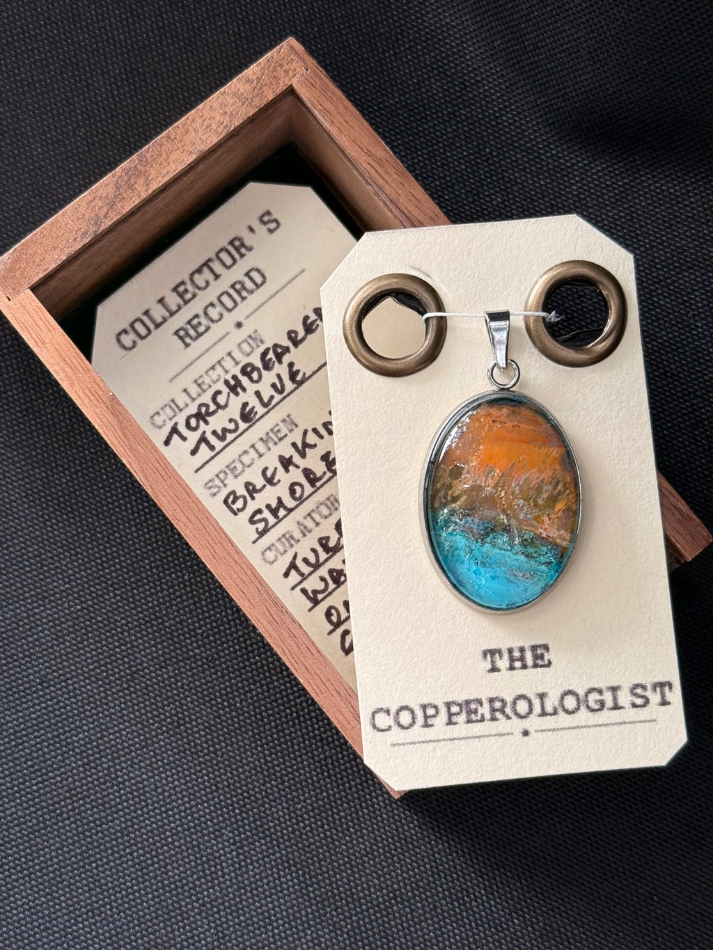 Breaking Shore - a one-of-a-kind copper pendant, presented in its wooden collector’s box with The Copperologist’s Collector’s Record card