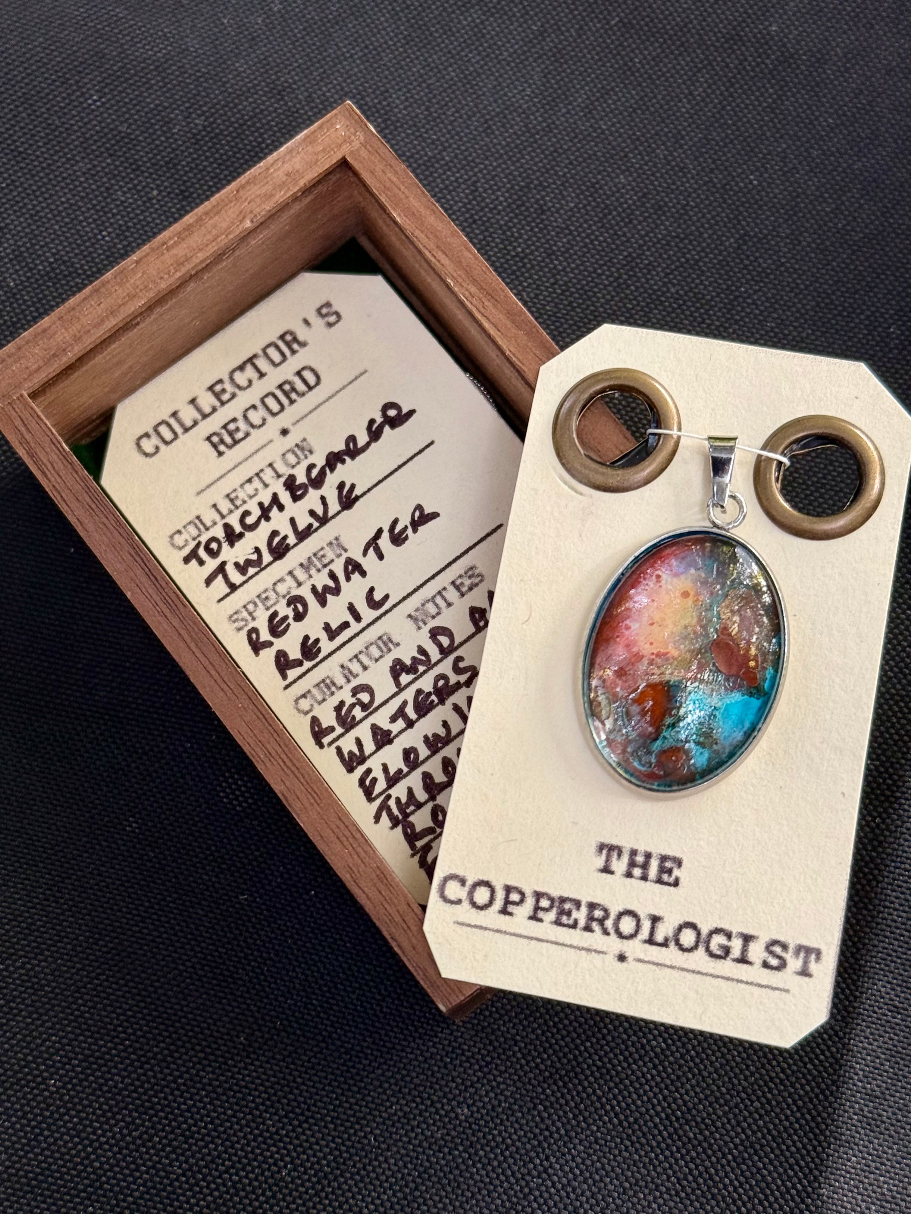 Redwater Relic - a one-of-a-kind copper pendant, presented in its wooden collector’s box with The Copperologist’s Collector’s Record card