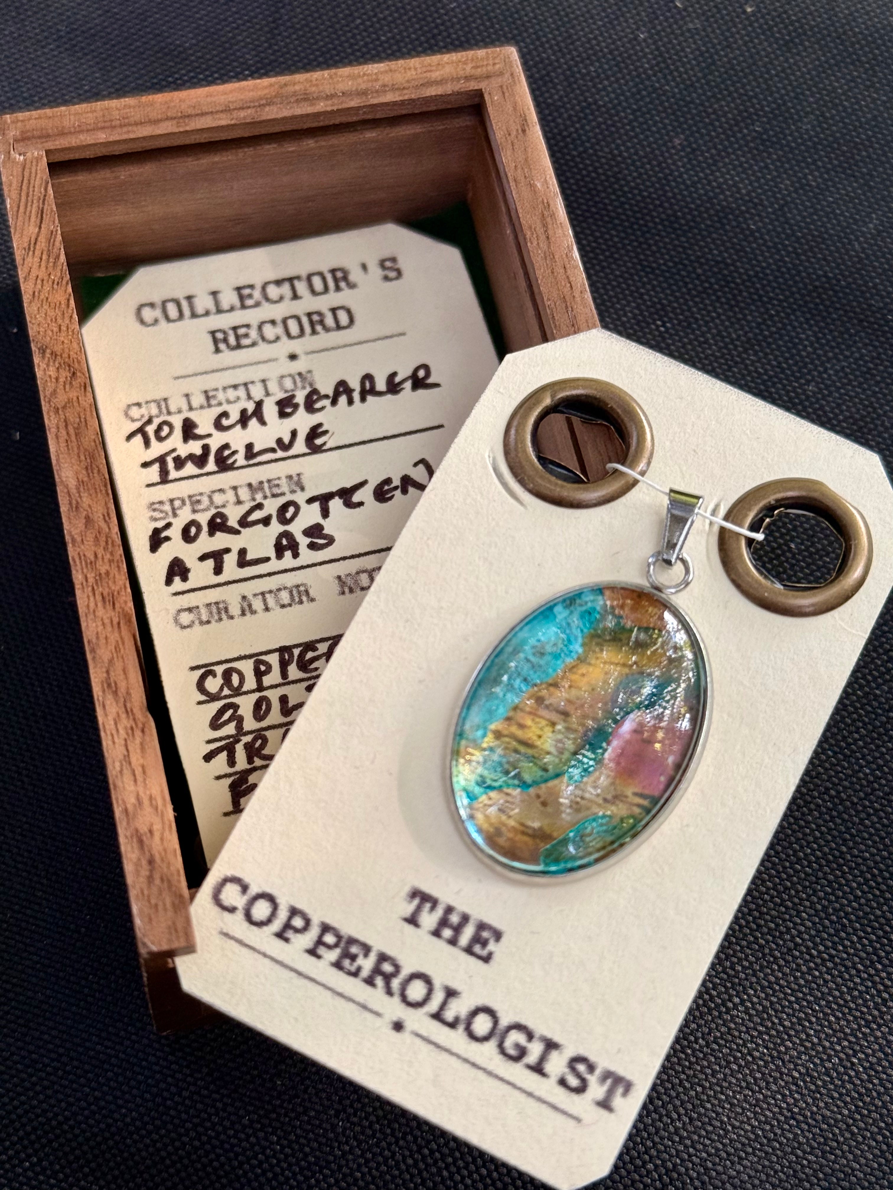Forgotten Atlas - a one-of-a-kind copper pendant, presented in its wooden collector’s box with The Copperologist’s Collector’s Record card