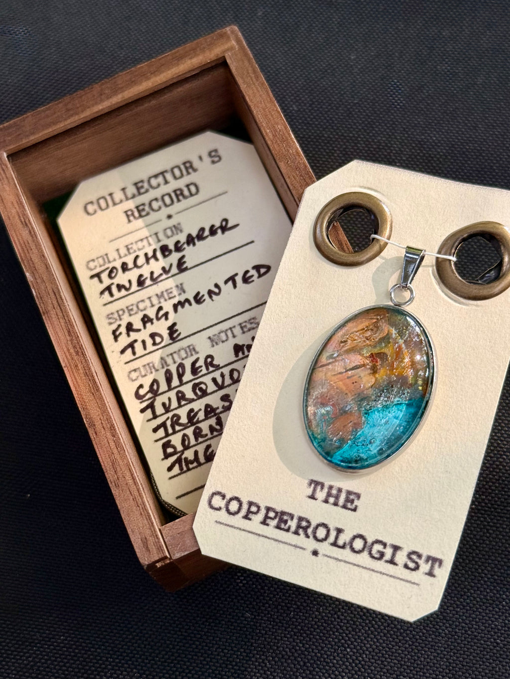 Fragmented Tide - a one-of-a-kind copper pendant, presented in its wooden collector’s box with The Copperologist’s Collector’s Record card
