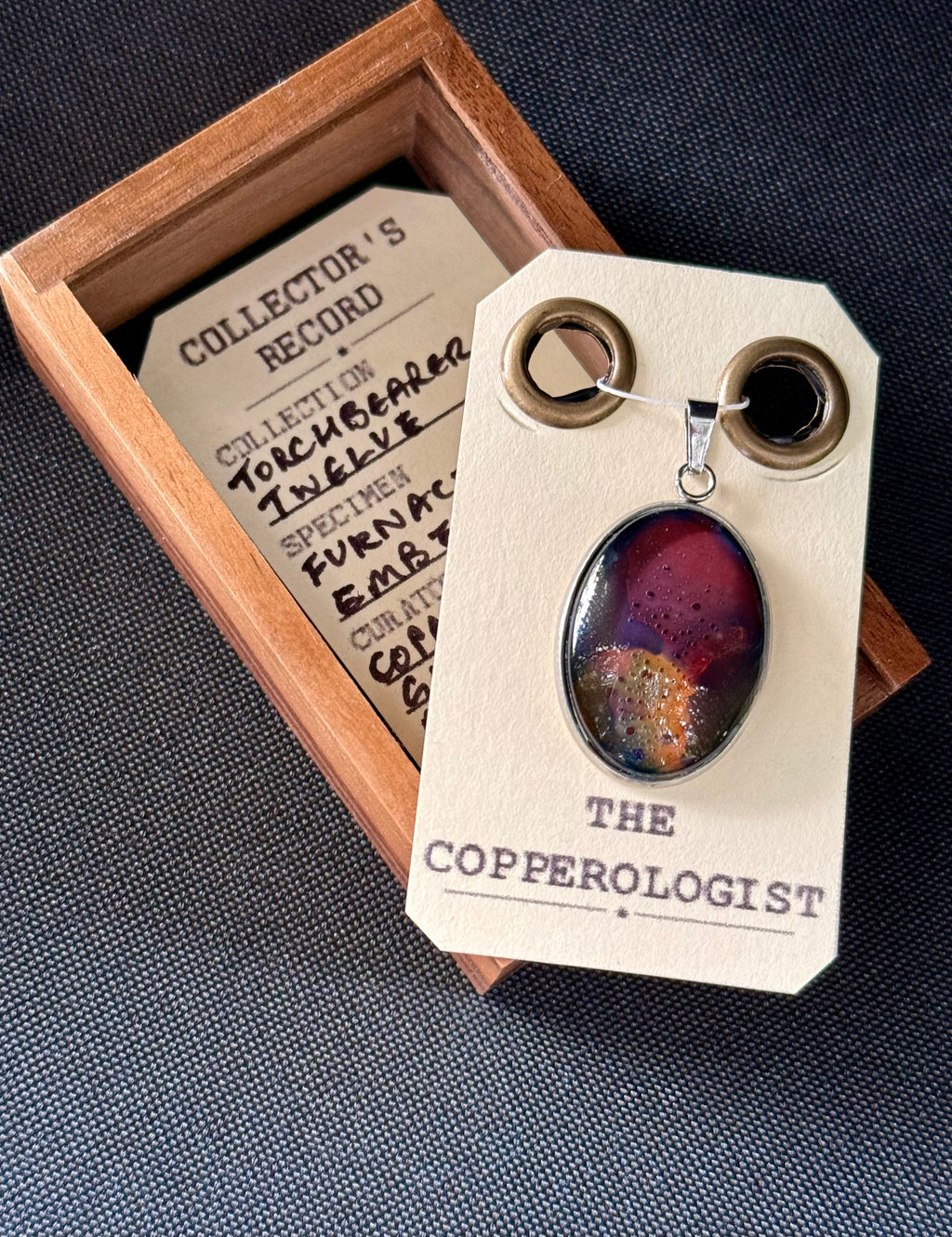 Furnace Ember - a one-of-a-kind copper pendant, presented in its wooden collector’s box with The Copperologist’s Collector’s Record card