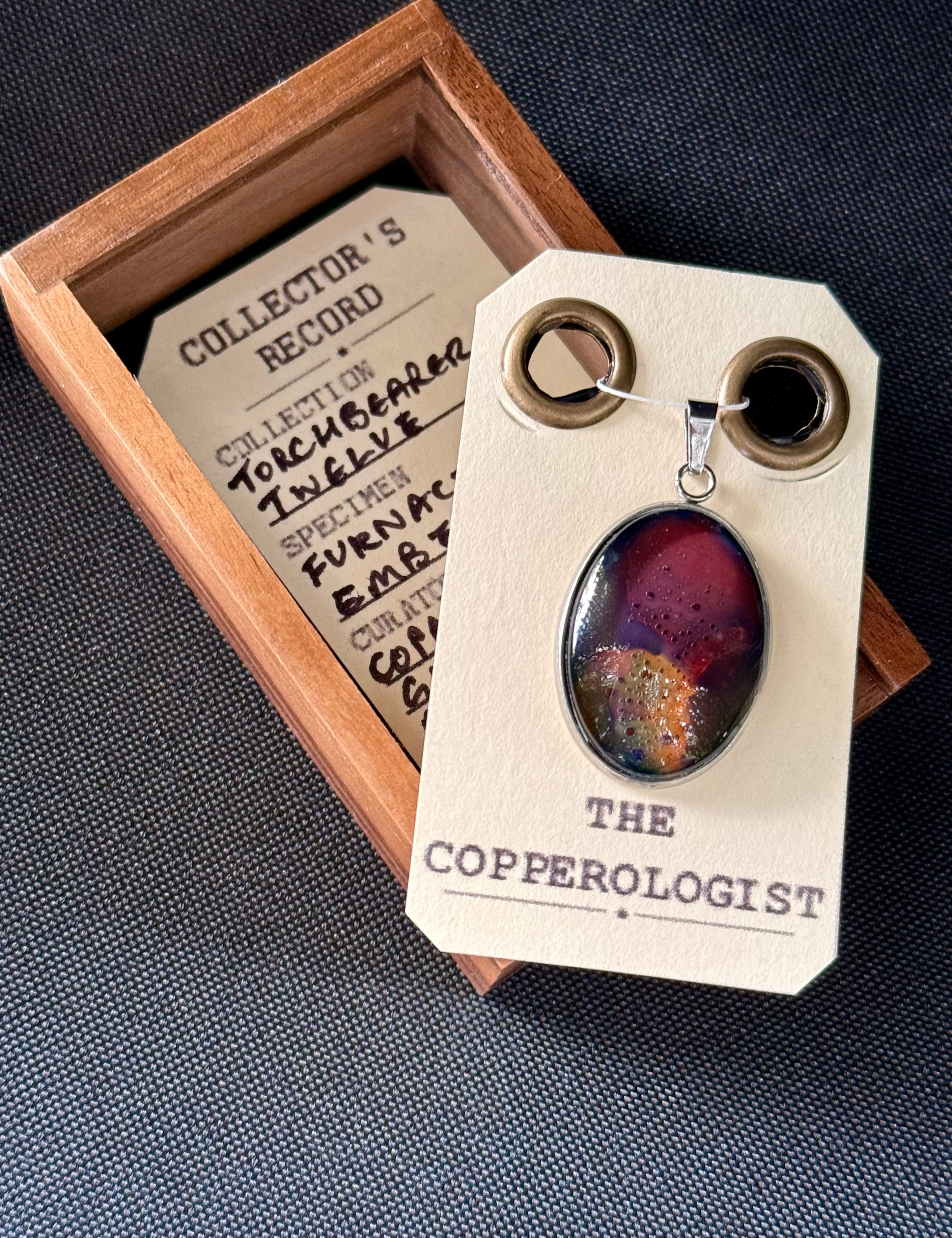 Furnace Ember - a one-of-a-kind copper pendant, presented in its wooden collector’s box with The Copperologist’s Collector’s Record card