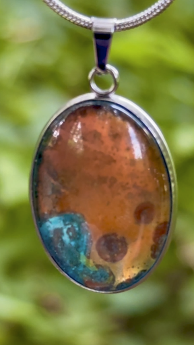 Torchbearer Twelve Specimen Eleven wearable copper specimen pendant featuring turquoise verdigris pools surrounding a central copper formation shaped by natural oxidation and transformation.