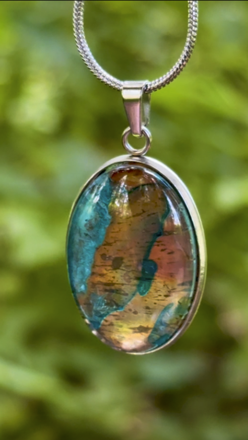 Torchbearer Twelve Specimen Nine wearable copper specimen pendant featuring layered verdigris blues and copper-gold striations reminiscent of an ancient geological map.
