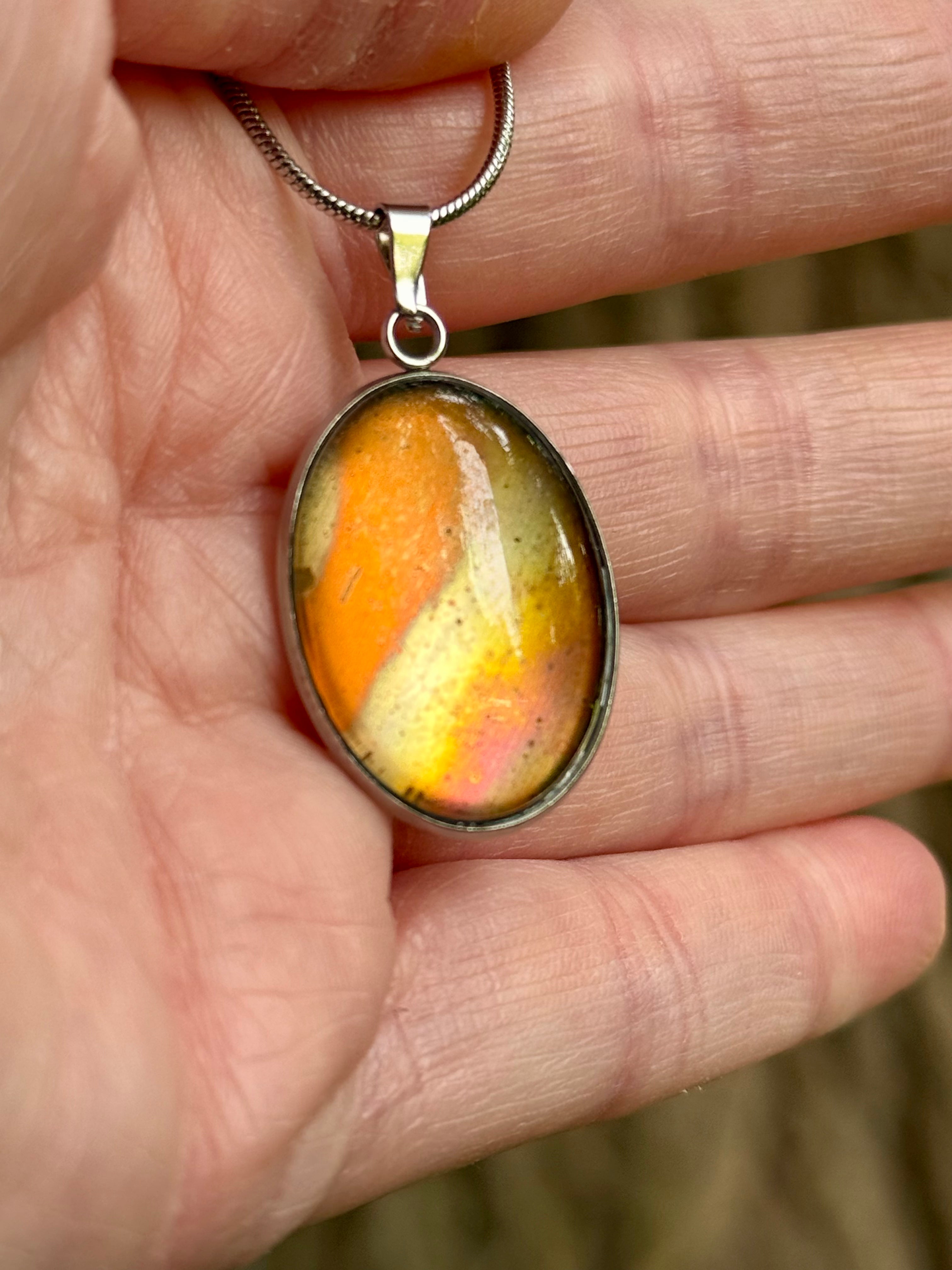 Torchbearer Twelve Specimen Ten wearable copper specimen pendant displaying vivid orange, gold and iridescent copper tones that resemble a miniature solar flare preserved beneath glass.
