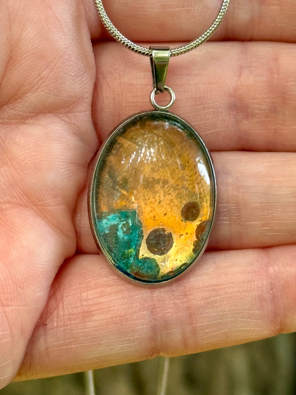 The Torchbearer Twelve Specimen Eleven one-of-a-kind copper pendant featuring vivid verdigris blues, copper-gold formations and naturally occurring mineral-like patterns preserved between glass and stainless steel.