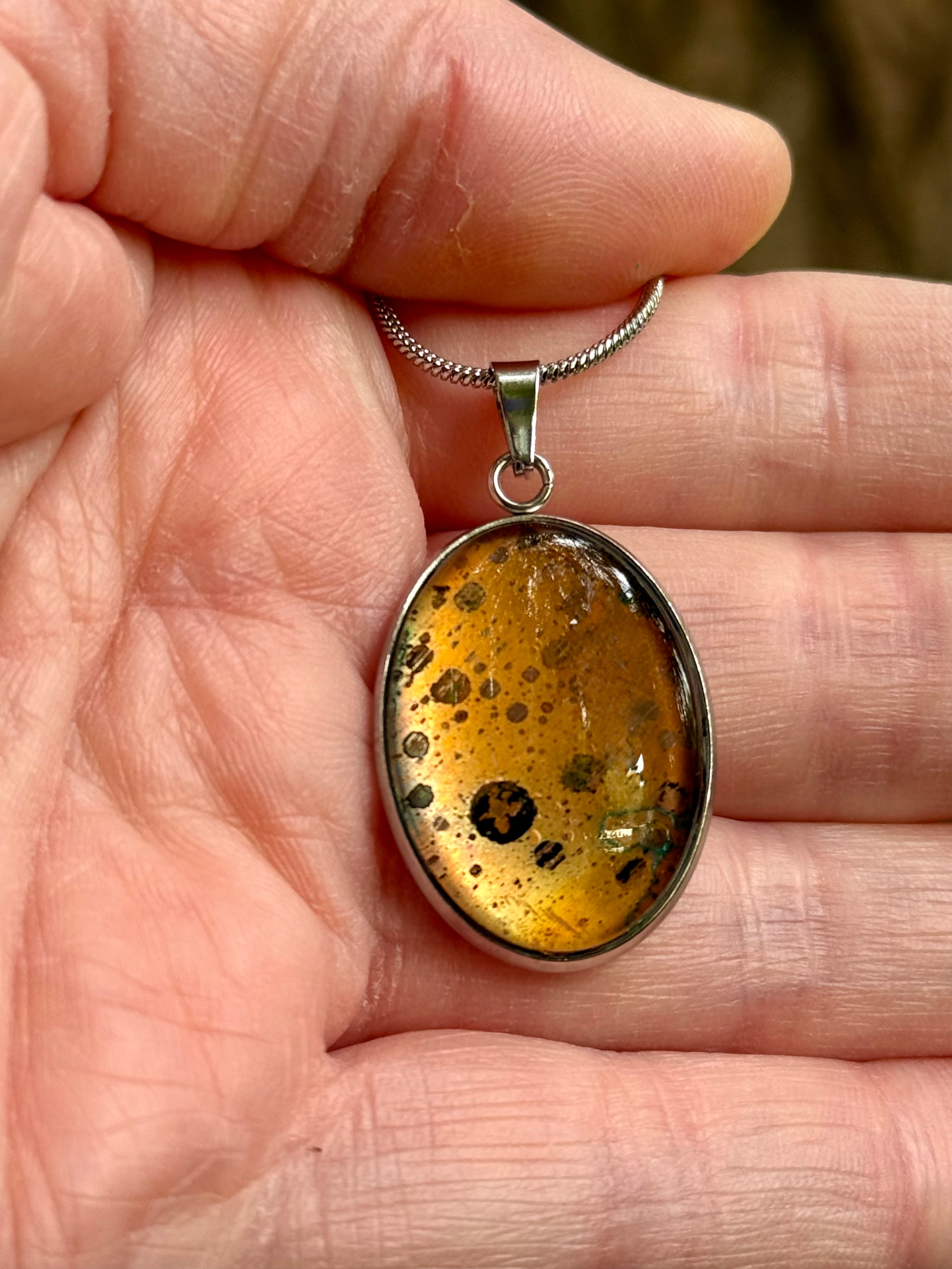 Torchbearer Twelve Specimen Twelve wearable copper specimen pendant displaying rich golden copper tones with distinctive circular mineral formations and naturally occurring patina patterns.