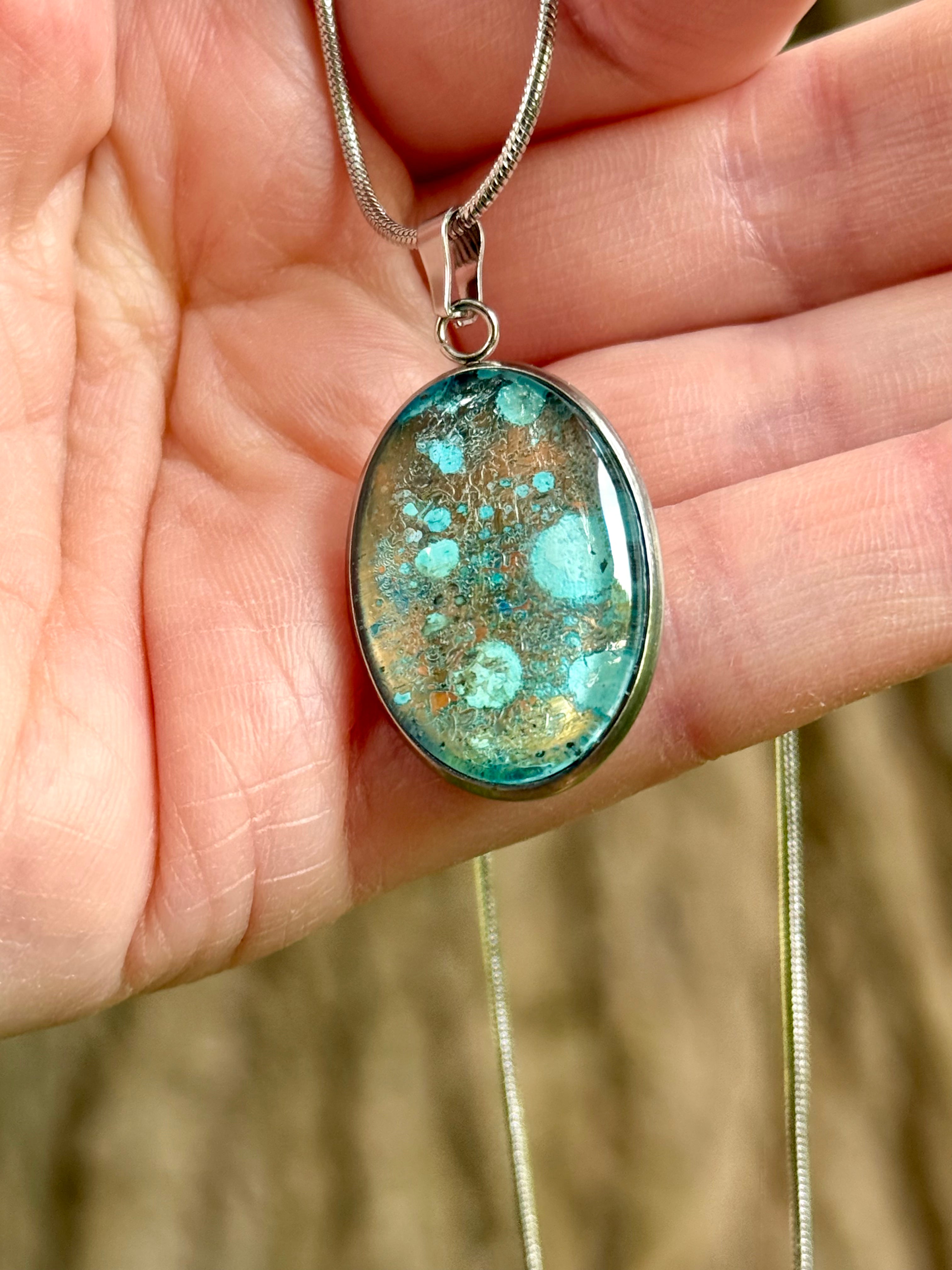 Torchbearer Twelve Specimen Three wearable copper specimen pendant featuring turquoise verdigris blooms scattered across an aged copper surface, creating the appearance of a miniature mineral field.