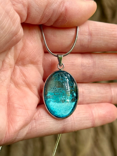 wearable copper specimen pendant displaying intense turquoise colouration and intricate crystalline textures developed through proprietary alchemical processes. For a collector who loves the sea.